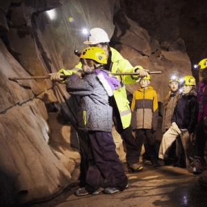 Group of children enjoying the underground mine tour at Honister Slate Mine
