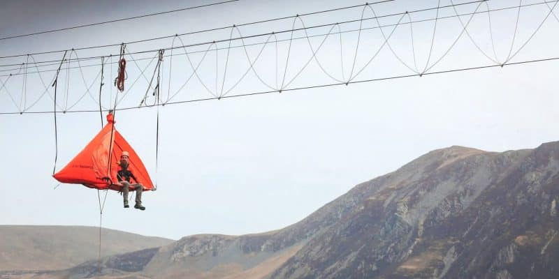 Man sitting in a tent during a cliff camping adventure at Honister Slate Mine in the Lake District